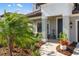 Welcoming home entrance with manicured landscaping and a cozy seating area on the covered front porch at 228 Caserta Ct, North Venice, FL 34275