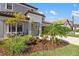 View of the home's landscaped front yard, entryway, garage and neutral exterior paint at 228 Caserta Ct, North Venice, FL 34275