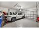 Garage featuring epoxy floors, lots of storage space, and space for parking an SUV at 228 Caserta Ct, North Venice, FL 34275