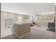 Spacious carpeted loft featuring bright windows and neutral-toned decor at 228 Caserta Ct, North Venice, FL 34275