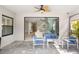 A covered outdoor patio with sleek outdoor seating offers indoor-outdoor living at 228 Caserta Ct, North Venice, FL 34275