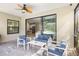 Covered patio with stylish seating area, ceiling fan, and sliding glass doors at 228 Caserta Ct, North Venice, FL 34275