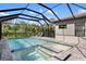 Stunning screened pool area with a hot tub, a spacious deck, and ample seating at 228 Caserta Ct, North Venice, FL 34275