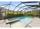A beautiful screened pool and patio area with lush landscaping surrounding at 228 Caserta Ct, North Venice, FL 34275