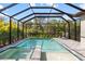 A beautiful screened-in pool with lush landscaping creates a private backyard oasis at 228 Caserta Ct, Nokomis, FL 34275