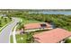Birds eye view of a home featuring a tile roof, pool, solar panels, and well-manicured lawn at 24036 Spartina Dr, Venice, FL 34293