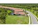 Aerial view of single Gathering home featuring a pool, solar panels, lush greenery, and well-manicured lawn at 24036 Spartina Dr, Venice, FL 34293