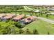 Aerial view of multiple single Gathering homes featuring solar panels, pools, and well-manicured lawns at 24036 Spartina Dr, Venice, FL 34293
