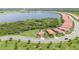 Panoramic aerial view of a neighborhood near a lake with single-Gathering homes and lush greenery at 24036 Spartina Dr, Venice, FL 34293