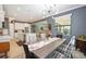Open concept dining room, with a modern table set and an open view to the kitchen and living room at 24036 Spartina Dr, Venice, FL 34293