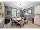 Modern dining room with a unique chandelier, stylish furnishings, and neutral colors at 24036 Spartina Dr, Venice, FL 34293