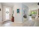 Bright foyer featuring a decorative glass front door, tile flooring, and an archway leading to other rooms at 24036 Spartina Dr, Venice, FL 34293