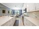 Well appointed white kitchen with bright counters and modern appliances offering ample counter space at 24036 Spartina Dr, Venice, FL 34293
