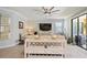 Open-concept living room with contemporary decor, tile flooring, large TV, and sliding glass doors to patio at 24036 Spartina Dr, Venice, FL 34293