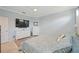Comfortable bedroom boasts neutral walls, tile floors, ceiling fan, and white trim, creating a warm and inviting space at 24036 Spartina Dr, Venice, FL 34293