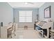Brightly lit office provides natural light, while the light-colored walls and modern desk offer a minimalist design at 24036 Spartina Dr, Venice, FL 34293