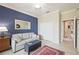 Relaxing sitting room boasts a blue accent wall, neutral carpeting and a comfortable sofa, a great place to unwind at 24036 Spartina Dr, Venice, FL 34293