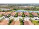 Aerial view showcases tile roofs and pond views in a residential neighborhood at 24044 Canterwood Way, Venice, FL 34293