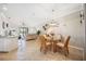 Charming dining area with glass table, wicker chairs, and view of the living room at 24044 Canterwood Way, Venice, FL 34293