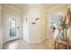 Bright entryway features tile floors and a decorative front door flowing into a living space at 24044 Canterwood Way, Venice, FL 34293