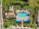 Birds eye view of community pool, hot tub, clubhouse, and verdant landscaping at 27440 Janzen Ct, Englewood, FL 34223