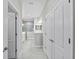 Hallway view to bathroom with double vanity and glass shower at 27440 Janzen Ct, Englewood, FL 34223
