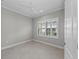 Sunlit bedroom with tiled flooring, ceiling fan, plantation shutters and crown molding at 27440 Janzen Ct, Englewood, FL 34223