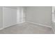 Bright bedroom with soft carpet, double closet, and plantation-style shutters for controlled natural light at 27440 Janzen Ct, Englewood, FL 34223