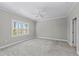 Comfortable bedroom with carpet and a large window for natural light at 27440 Janzen Ct, Englewood, FL 34223