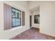 Covered entryway with brick paving, leading to the front door of the home at 27440 Janzen Ct, Englewood, FL 34223