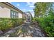 Lush landscaping flanks the exterior of this home with a screened-in lanai at 27440 Janzen Ct, Englewood, FL 34223
