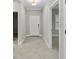 Inviting hallway with neutral paint, tile flooring, and an entryway leading to other rooms at 27440 Janzen Ct, Englewood, FL 34223