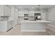 Bright, open kitchen with stainless steel appliances, an island and granite countertops at 27440 Janzen Ct, Englewood, FL 34223