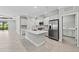 Bright, open kitchen with stainless steel appliances, an island and granite countertops at 27440 Janzen Ct, Englewood, FL 34223