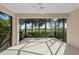 Spacious screened lanai providing an outdoor living space with views of the surrounding landscape at 27440 Janzen Ct, Englewood, FL 34223