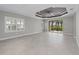 Bright living room with tile floors, recessed lighting, and sliding glass doors to the lanai at 27440 Janzen Ct, Englewood, FL 34223