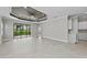 Bright and airy living room with tile floors, recessed lighting, and sliding glass doors at 27440 Janzen Ct, Englewood, FL 34223