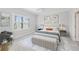 Well-lit main bedroom with neutral tones, plantation shutters, and a comfortable sitting area at 27440 Janzen Ct, Englewood, FL 34223