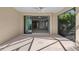 Covered patio with a ceiling fan and sliding glass doors, great for entertaining guests at 27440 Janzen Ct, Englewood, FL 34223