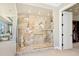 This bathroom features a glass shower with tile surround, a seahorse statue, and a view of the bedroom and ocean view at 2821 Casey Key Rd, Nokomis, FL 34275
