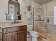 Modern bathroom with marble countertop, glass shower, and decorative accents at 2821 Casey Key Rd, Nokomis, FL 34275