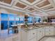 Gourmet kitchen with stone countertops, ocean views, and modern lighting fixtures creates a luxurious experience at 2821 Casey Key Rd, Nokomis, FL 34275