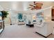 Spacious living room with plush white seating, artistic decor, and a unique ceiling fan at 2821 Casey Key Rd, Nokomis, FL 34275