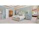 This main bedroom features a tray ceiling, a bed with matching bedside tables, and an ensuite bathroom at 2821 Casey Key Rd, Nokomis, FL 34275