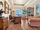 Elegant office with hardwood floors, built-in shelves, large desk, and ocean view at 2821 Casey Key Rd, Nokomis, FL 34275