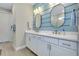 Bright bathroom featuring double sinks with white cabinets and modern oval mirrors at 29260 Coral Harbour Dr, Englewood, FL 34223