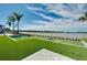 Lush outdoor game area with artificial turf, cornhole boards, and serene lake views at 29260 Coral Harbour Dr, Englewood, FL 34223