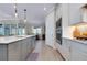 A view of the kitchen island with oven and a view to the dining area at 29260 Coral Harbour Dr, Englewood, FL 34223