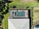 Aerial view of a screened-in pool with patio furniture and manicured lawn at 29260 Coral Harbour Dr, Englewood, FL 34223