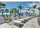 Relaxing poolside lounge area with rows of comfortable chaise lounges and shade umbrellas amid tropical greenery at 29260 Coral Harbour Dr, Englewood, FL 34223